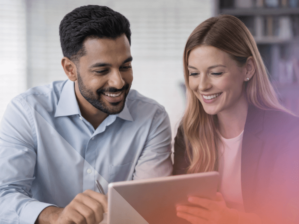 Two people looking at a device in a work environment