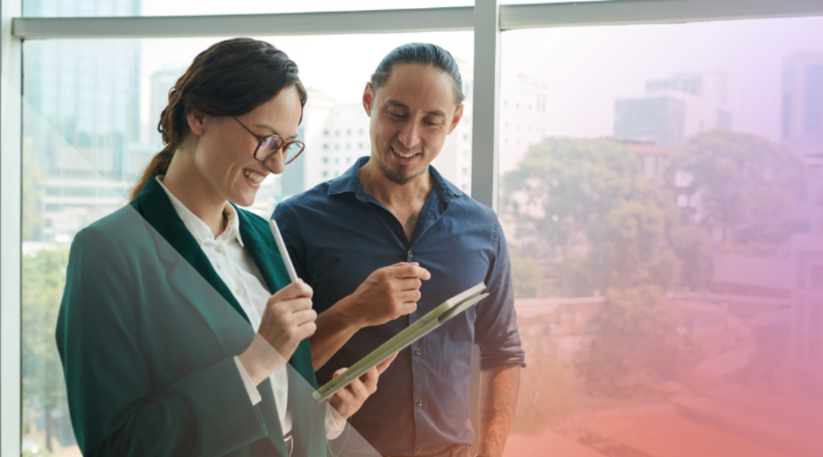 Two colleagues looking happy because they have a clean CRM